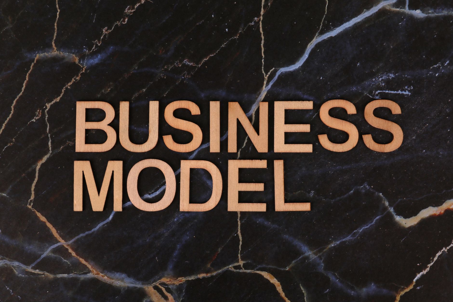 wooden business model letters on marble
